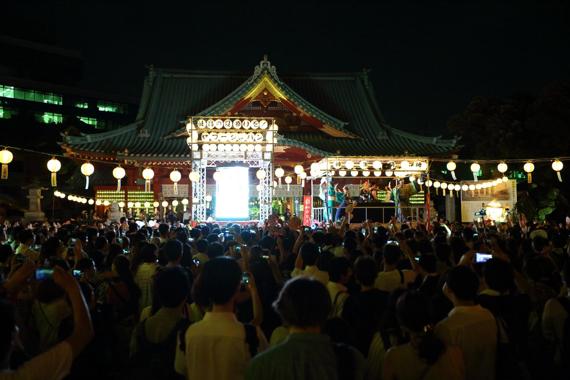 提灯の明かりが灯された靖国神社に集まった大勢の方々の後ろ姿を写した写真